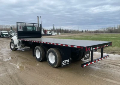 Flat deck truck installed with custom flatbed truck body.