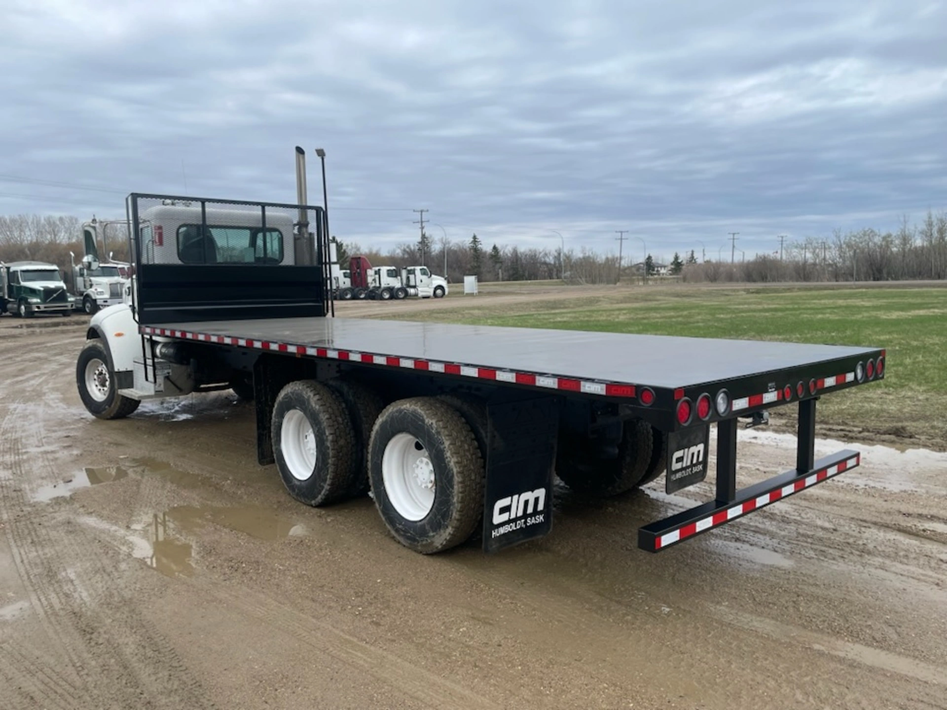 An empty flat bed truck waiting for fresh cargo.