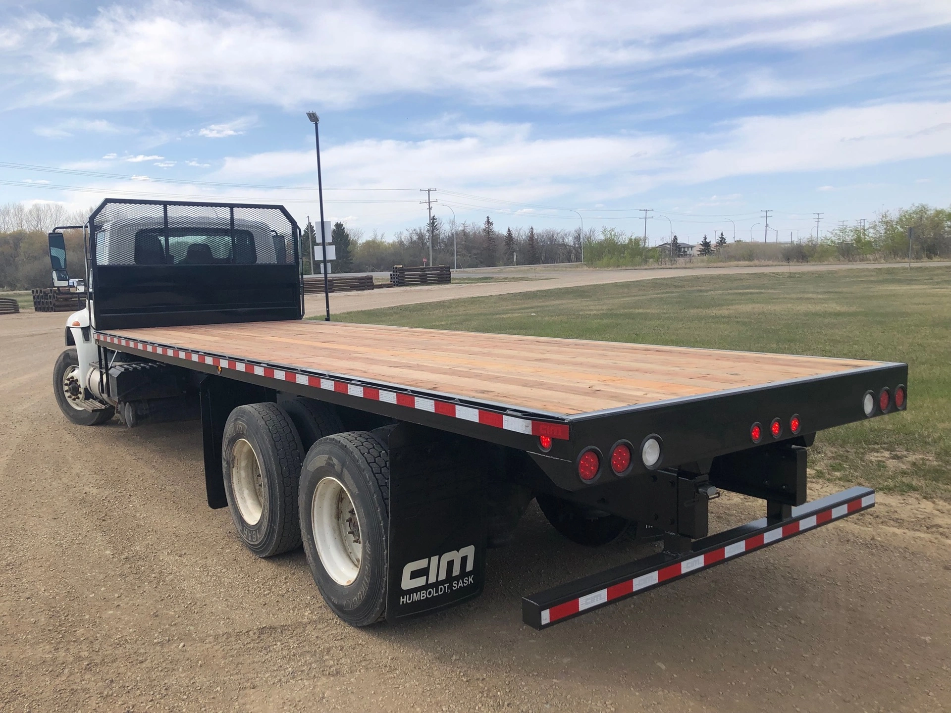 Heavy Duty Commercial" Tag text: An empty flat bed truck waiting for cargo.