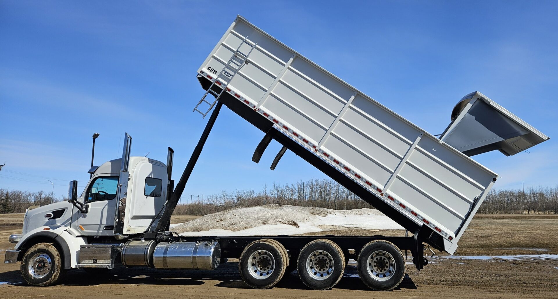 A custom grain trailer with hatch extended for grain.